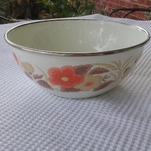 Vintage Emaille Schale mit floralen Akzenten um ihn herum.