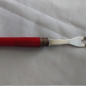 vintage cooking fork, stainless with bright red bakelite handle.