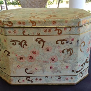 vintage Meister tin made in Brazil.  Floral with gold scrolls throughout.