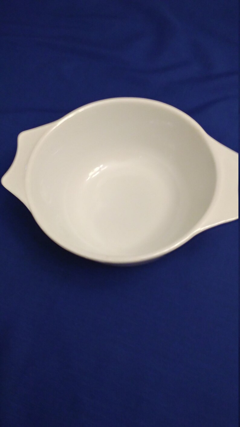 Pyrex small baking dish with blue and maroon flowers made in England.