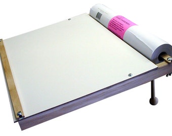 May include: A wooden drawing board with a roll of paper attached to the side. The board is angled and has a wooden leg. The paper roll has a pink label that says "Easel Paper Roll".