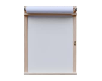 May include: A wooden drawing board with a roll of white paper attached to the top. The board has a small wooden frame and a label that says "BEKA" on the side.