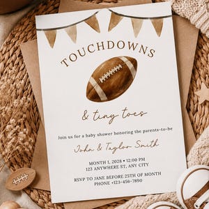 May include: A white rectangular baby shower invitation card featuring a brown watercolor football, brown bunting flags, and the text TOUCHDOWNS & tiny toes. The card includes details for John & Taylor Smith, a date, time, location, and RSVP contact info.