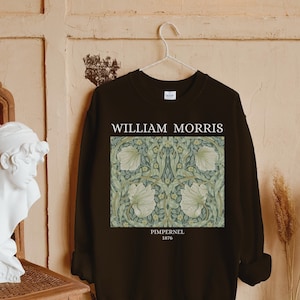 May include: Black sweatshirt with a white print of a floral design by William Morris. The print includes the text "Pimpernel 1876".