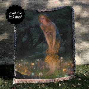 May include: Woven throw blanket featuring a classical painting of a woman in a yellow dress in a forest scene with fairies. The blanket has a fringed edge and the text "available in 3 sizes!" in a black circle.