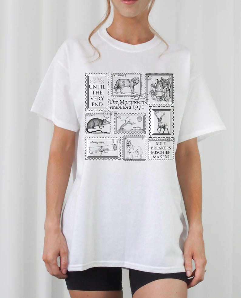 May include: White t-shirt with a black graphic print of stamps featuring illustrations of animals and the text "Until the very end, The Marauders established 1971, Rule Breakers Mischief Makers".