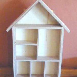 Wooden House Shaped Display Shelves Unit Suitable to display Small Ornaments, Dolls House Miniatures, Thimbles, Lego Figures The unit measures 30cm High x 22cm Wide x 4.5cm Deep Can be Free-Standing or Wall Mounted. Supplied with two hanging hooks.