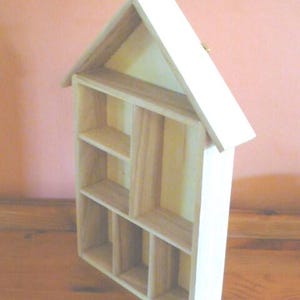 Wooden House Shaped Display Shelves Unit Suitable to display Small Ornaments, Dolls House Miniatures, Thimbles, Lego Figures The unit measures 30cm High x 22cm Wide x 4.5cm Deep Can be Free-Standing or Wall Mounted. Supplied with two hanging hooks.