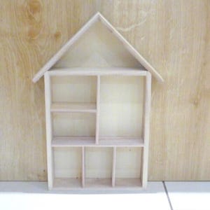 Wooden House Shaped Display Shelves Unit Suitable to display Small Ornaments, Dolls House Miniatures, Thimbles, Lego Figures The unit measures 30cm High x 22cm Wide x 4.5cm Deep Can be Free-Standing or Wall Mounted. Supplied with two hanging hooks.