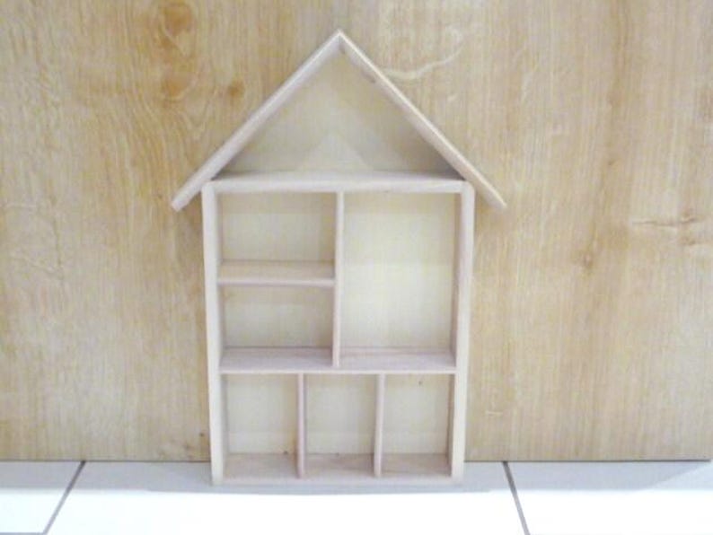 Wooden House Shaped Display Shelves Unit Suitable to display Small Ornaments, Dolls House Miniatures, Thimbles, Lego Figures The unit measures 30cm High x 22cm Wide x 4.5cm Deep Can be Free-Standing or Wall Mounted. Supplied with two hanging hooks.