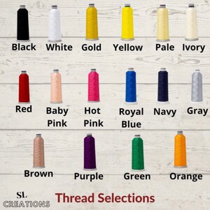 May include: A chart of thread colors with the names of each color listed below. The colors include black, white, gold, yellow, pale, ivory, red, baby pink, hot pink, royal blue, navy, gray, brown, purple, green, and orange.