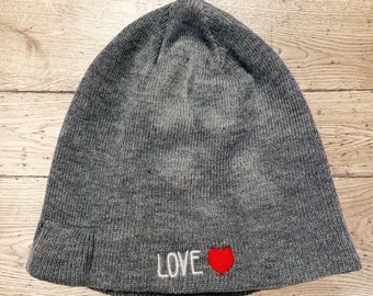 May include: Gray knit beanie with a red heart and the word "LOVE" embroidered on the front.