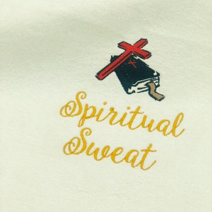 May include: White sweatshirt with gold embroidery that reads "Spiritual Sweat" and a black and red illustration of a book with a cross on top.