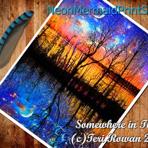 May include: A digital art print of a colorful, starry night sky reflected in a still body of water. The sky is a mix of blue, purple, pink, and orange hues with a crescent moon and stars. The reflection in the water is a mirror image of the sky. The text "Somewhere in Time (c) Teri Rowan 2016" is at the bottom of the print.