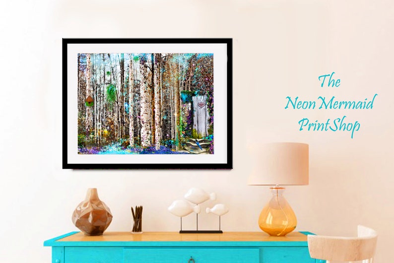 May include: A framed abstract painting of a forest with birch trees, colorful foliage, and a blue bird. The painting has a white background and a black frame. The painting is hanging on a white wall above a blue dresser.