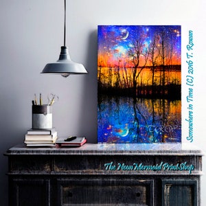 May include: A digital painting of a starry night sky reflected in a still body of water. The sky is a vibrant blue with streaks of orange and yellow. The water is a deep blue with a reflection of the sky and trees. The trees are silhouetted against the sky and water. The painting is titled "Somewhere in Time (C) 2016 T. Rowan".