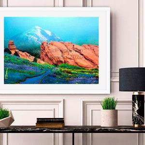May include: A framed photograph of a mountain landscape with red rock formations and a blue sky. The photo is framed in a white frame and is hanging on a white wall. The photo is titled "Neon Mermaid Prints" and the date "18 November 2020" is printed on the bottom right corner.