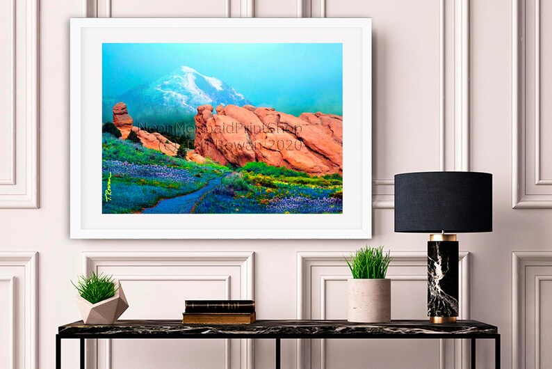 May include: A framed photograph of a mountain landscape with red rock formations and a blue sky. The photo is framed in a white frame and is hanging on a white wall. The photo is titled "Neon Mermaid Prints" and the date "18 November 2020" is printed on the bottom right corner.