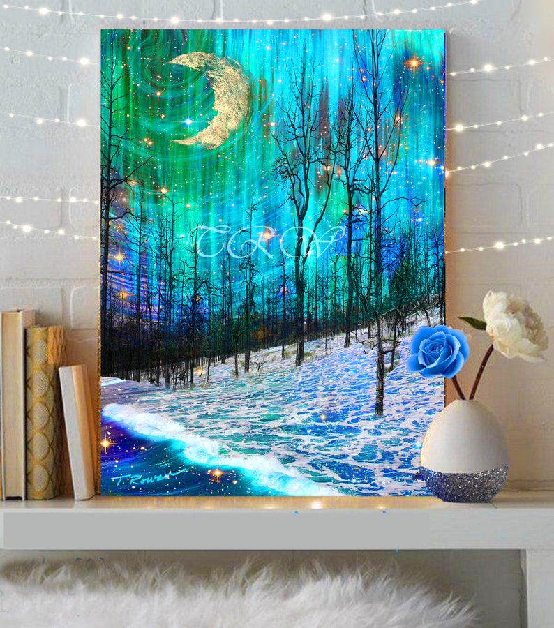 A crescent moon hangs over a wave like snow covered hill of trees while the Northern Lights blaze overhead.
