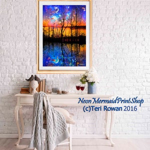 May include: A framed print of a colorful landscape with a lake, trees, and a starry sky. The reflection of the scene is visible in the water. The print is titled "Neon Mermaid Print Shop (c) Teri Rowan 2016".