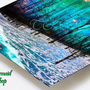 May include: A digital art print depicting a dark forest with bare trees and a blue and green aurora borealis in the sky. The forest is reflected in the water below, which is a turquoise blue with white foam.