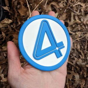 May include: A blue and white circular coaster with the number "4" in a stylized font.