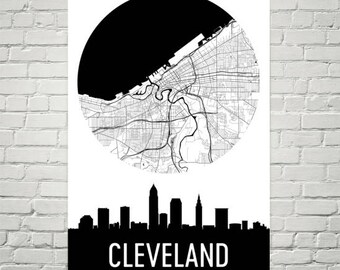 May include: Black and white city map of Cleveland, Ohio, with a black circle around the map. Below the map is a black silhouette of the Cleveland skyline with the word "CLEVELAND" in white text.