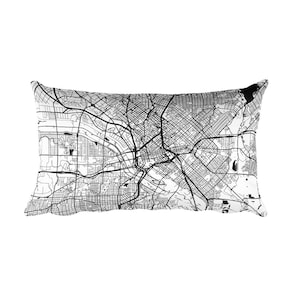 May include: A black and white map of a city printed on a rectangular pillow. The pillow is white with a black outline.