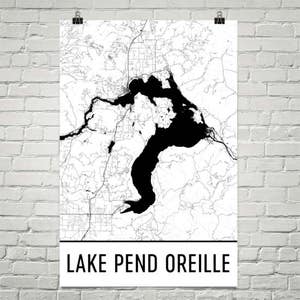 May include: A black and white map print of Lake Pend Oreille. The map shows the lake's outline and surrounding areas with roads and waterways. The words "LAKE PEND OREILLE" are printed in a bold, black font at the bottom of the print.