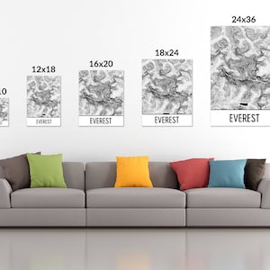 May include: A series of five framed art prints of Mount Everest, each with a unique size, ranging from 8x10 inches to 24x36 inches. The prints feature a black and white topographical design with the word "EVEREST" at the bottom.