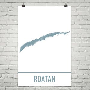 May include: A white poster with a teal map of Roatan, Honduras. The map is centered on the poster and is above a teal horizontal line. Below the line is the word "ROATAN" in teal block letters.