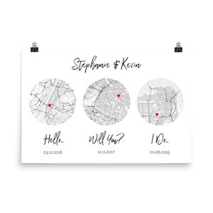 May include: A white rectangular print featuring the names Stephanie & Kevin at the top. Below are three circular black and white city maps, each marked with a small red heart. Text below the maps reads Hello... 03.12.2016, Will You? 11.11.2017, and I Do... 01.06.2019.