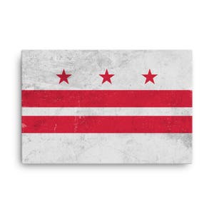 May include: A distressed, white canvas print of the flag of Washington, D.C. The flag features three red stars and three red stripes on a white background.