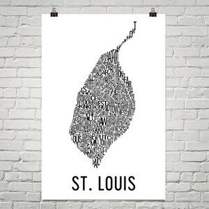 May include: A black and white typography art print of the city of St. Louis, Missouri. The print features the names of different neighborhoods in the city, arranged in the shape of the city's outline.