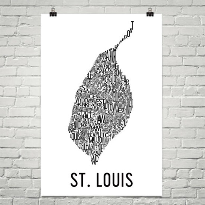 May include: A black and white typography art print of the city of St. Louis, Missouri. The print features the names of different neighborhoods in the city, arranged in the shape of the city's outline.