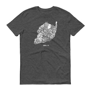 May include: Dark gray t-shirt featuring a detailed white map of Lisbon, Portugal. The map includes streets and landmarks, with the text "LISBON + PT" below the map. The shirt is a crew neck style.