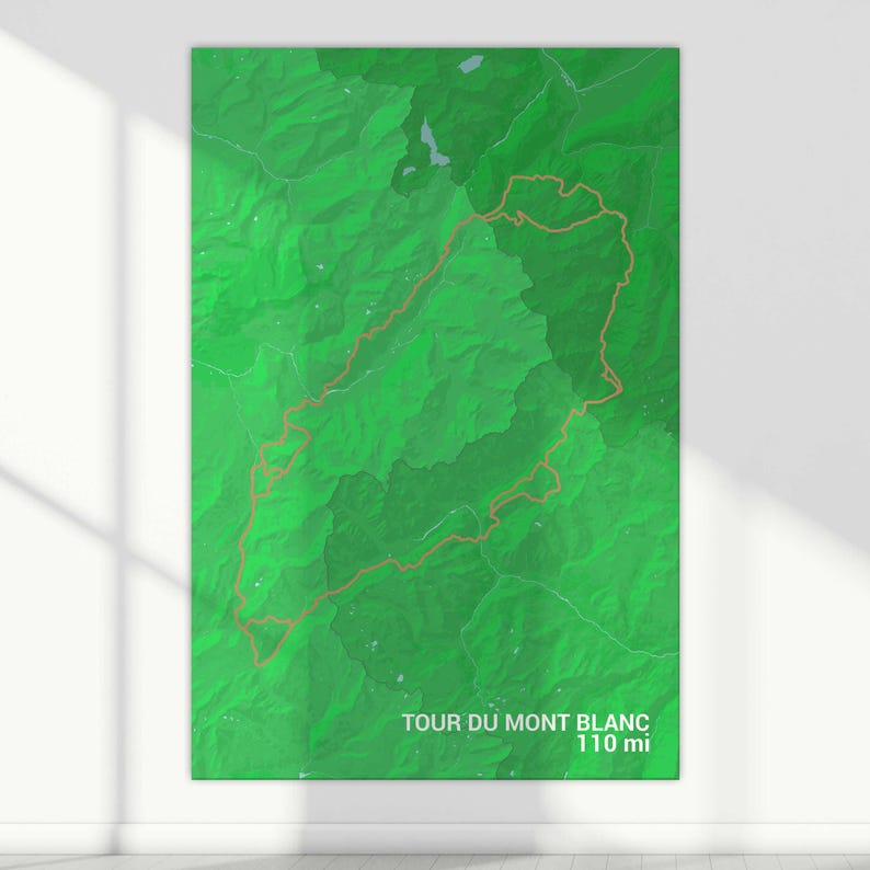 May include: A green map with a brown line tracing the Tour du Mont Blanc trail, which is 110 miles long.