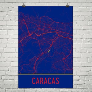 May include: A blue and red map of Caracas, Venezuela. The city name is written in red at the bottom of the map.