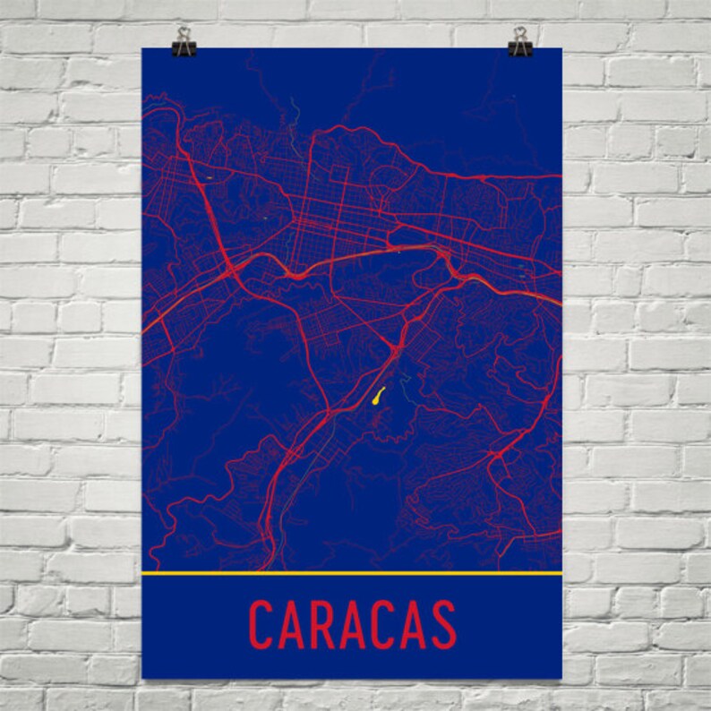 May include: A blue and red map of Caracas, Venezuela. The city name is written in red at the bottom of the map.