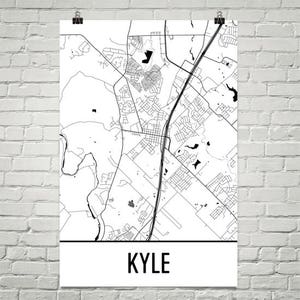 May include: A black and white map of Kyle, Texas. The map shows the city's streets and roads, as well as some of its parks and other features. The word "KYLE" is printed in bold, black letters at the bottom of the map.