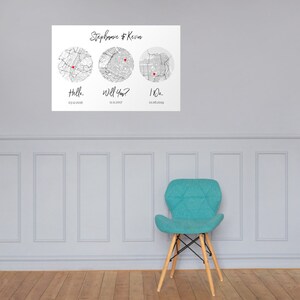 May include: A white rectangular wall print featuring the text Stephanie & Kevin at the top. Below are three circular black and white city maps, each marked with a small red heart. The text Hello, Will You?, and I Do appear with dates below.