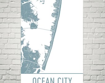 May include: A blue and white map print of Ocean City, Maryland. The map shows the city's streets and coastline. The city name is printed in blue at the bottom of the map.