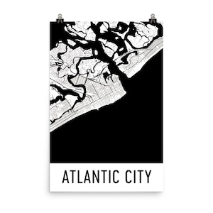 May include: A black and white map of Atlantic City, New Jersey, with a detailed depiction of the city's layout, including streets, waterways, and coastal features. The city name is printed in bold, black letters at the bottom.