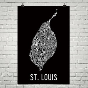 May include: A black and white typography art print of the city of St. Louis, Missouri. The print features the names of different neighborhoods in the city, arranged in the shape of the city's outline.