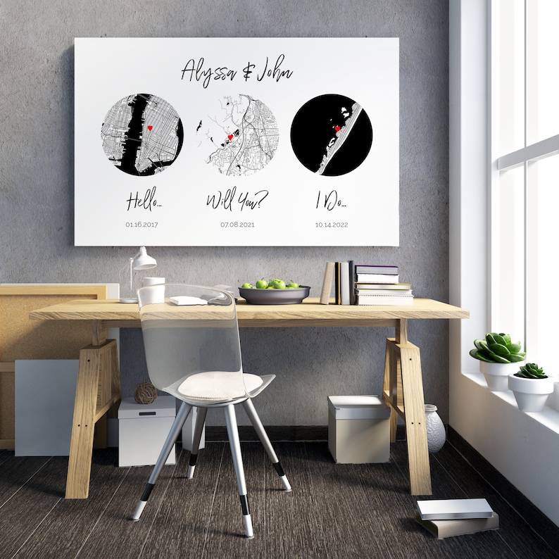 May include: A rectangular wall art print featuring the names Alyssa & John at the top. Below are three circular map illustrations, each marked with a small red heart. Text below the maps reads Hello... 01.16.2017, Will You? 07.08.2021, and I Do... 10.14.2022.