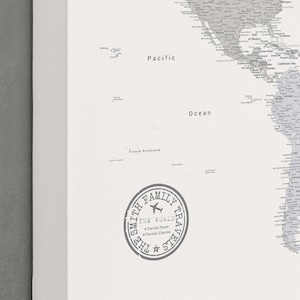 May include: A black and white world map print with the text "Pacific Ocean" and "French Polynesia." A circular stamp reads "The Smith Family Travels" with the words "Travels Taken" and "Travels Planned."