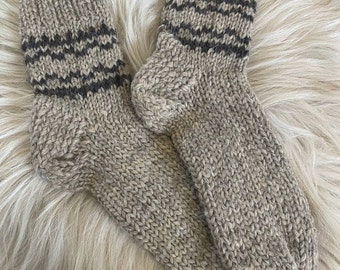 May include: A pair of brown knitted socks with black stripes. The socks are made of wool and have a comfortable fit.