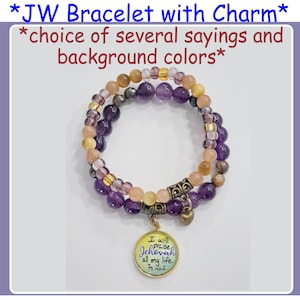May include: A double-strand bracelet with purple and yellow beads and a charm with the text "I will praise Jehovah all my life. Ps 146:2".