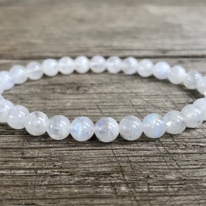 May include: A white moonstone bracelet with round beads. The bracelet is made of natural stones and is a popular choice for jewelry.