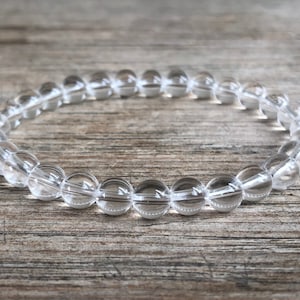 May include: A clear quartz crystal bracelet with round beads.